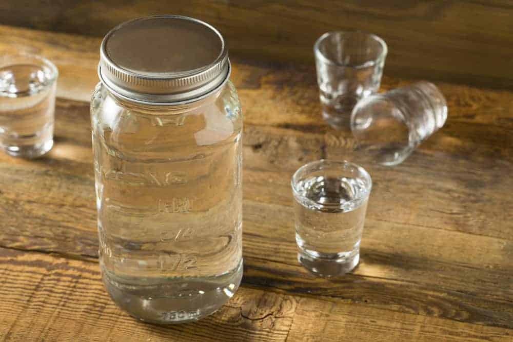 jar and shots of moonshine