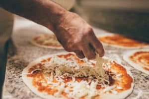 person making a pizza