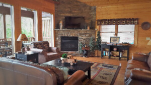 Open concept living room with gas fireplace and lots of windows