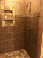Tiled shower in main floor bathroom
