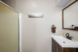 Lower level Queen Suite #1 full bathroom with tiled shower and mountain views