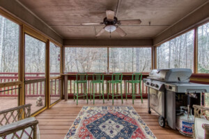 Screened in room off right bedroom with grill and bar overlooking the river