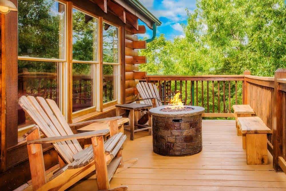 deck of a Pigeon Forge cabin with a fire pit