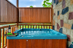 Hot tub with a view and with safety railing located on the deck.