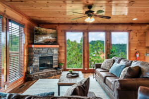 Beautiful comfy living room.  The sun will rise over the mountains through these picture windows.