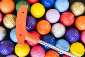 colorful mini golf balls and club