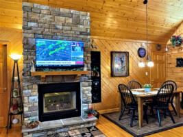 Large screen HDTV over fireplace and inviting dining area