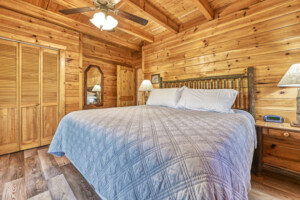 Main level Bedroom 1 with king bed and private entrance onto the covered deck