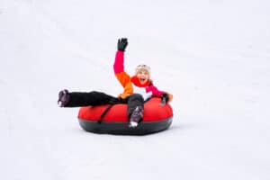 girl on snow tubing hill