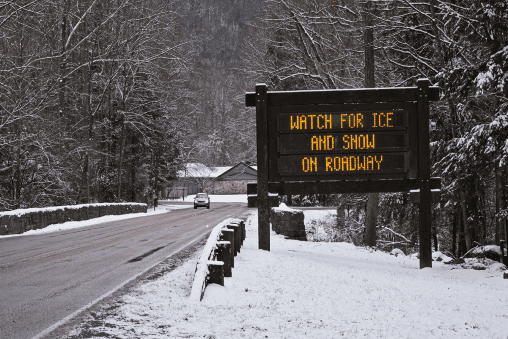 sign reads watch for ice and snow on roadway
