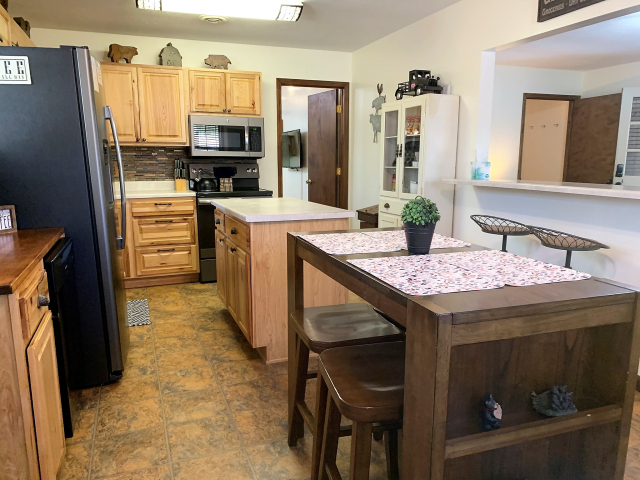 Kitchen and dining area.  Table seats 4 and there is also seats at the bar. 