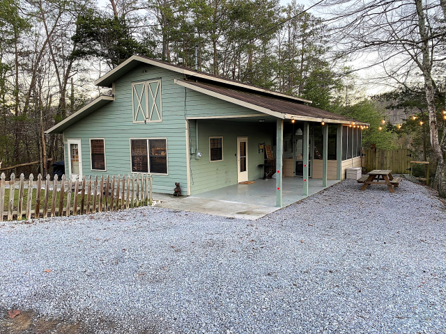 Farm style cottage with a covered carport. Picnic table and large fenced in backyard. Located on over 2 acres. 
