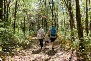 family hikes through woods