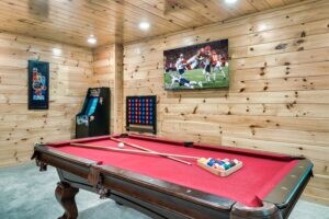 Gameroom with pool table, arcade game and large TV