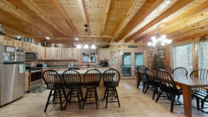 Open concept rental cabin in pigeon forge showing fully equiped kitchen with 4 counter bar stools