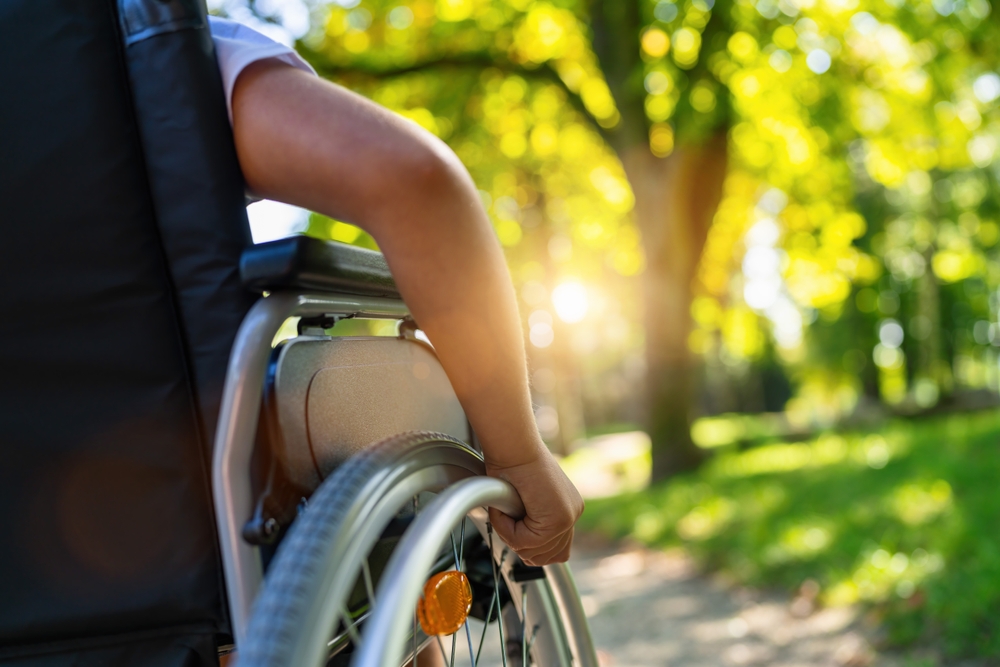 hand on wheelchair outdoors
