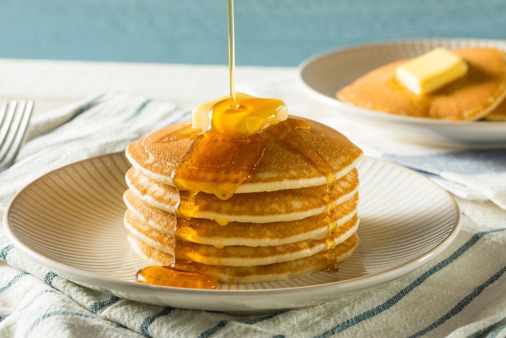 stack of pancakes with butter and syrup