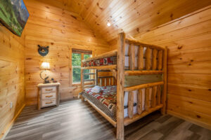 Upstairs bedroom with cabin-style queen bunk beds & attached bathroom