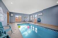 The heated indoor pool is located on the lower level of the cabin. A code to the lock on the door will be provided. The sliding door opens to the lower deck and hot tub outside.