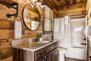 Main level bedroom bathroom with a bath tub/shower combo.
